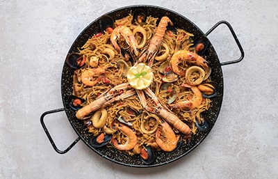 Paella - A mouth-watering Spanish dish made with rice, seafood, and vegetables