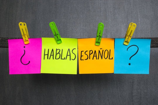 Colorful sticky notes on a string with '¿Hablas Español?' written, prompting the question of Spanish language proficiency.