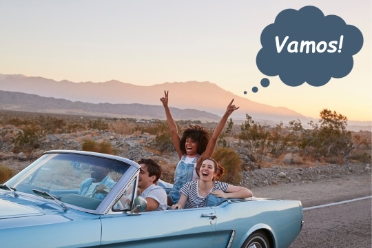 A lively scene of friends enjoying a road trip, filled with laughter and excitement as they shout 'Vamos' in unison.