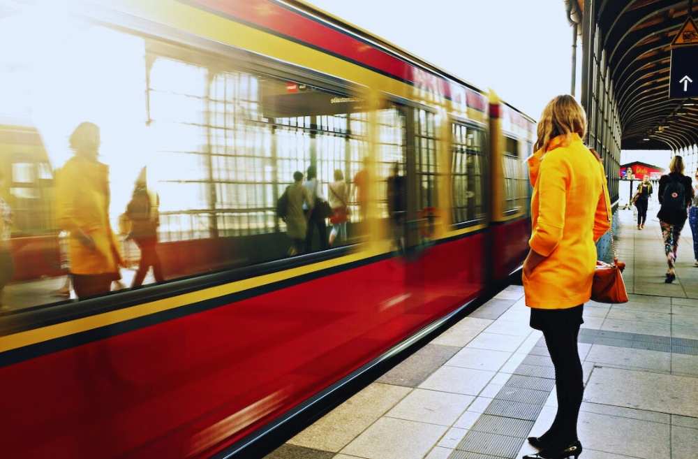 A young woman traveller taking railway transportation, illustrating a Language Vibes blog post about essential spanish transportation phrases