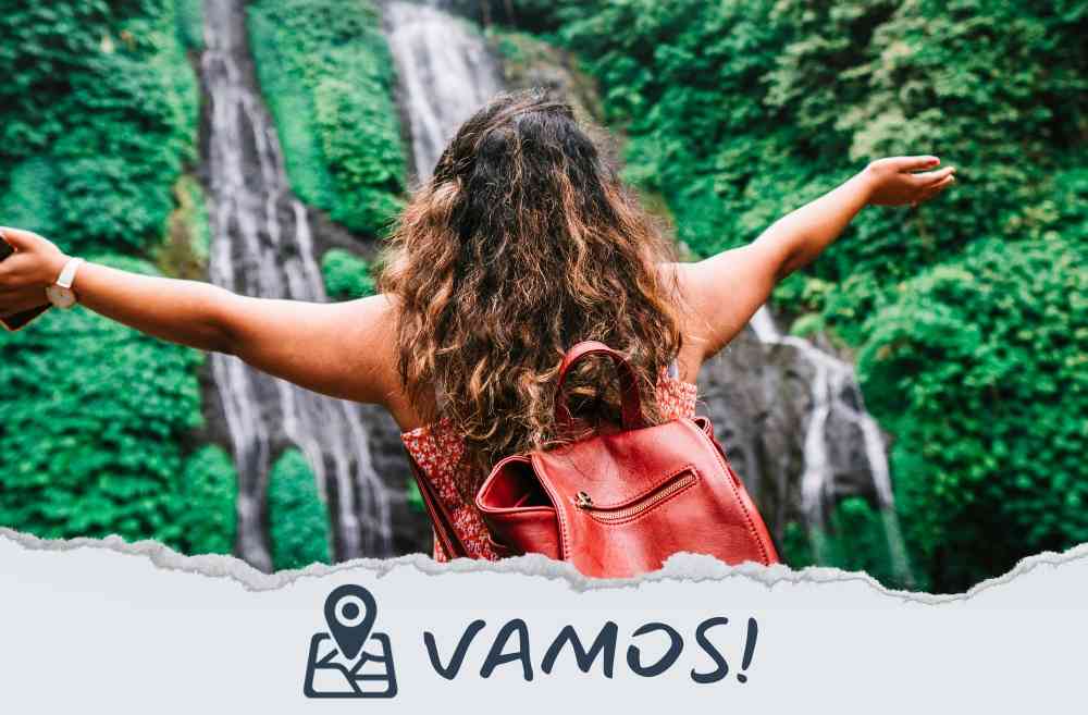 A lady immersed in the joy of trekking in a scenic waterfall zone, 'Vamos' inscribed in the image, capturing the spirit of adventure and exploration.